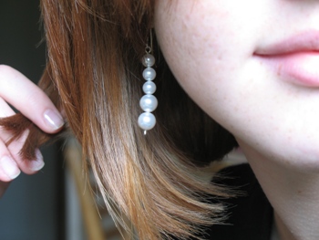 This photo of a young woman modelling a pair of pearl "dangle" earrings was taken by US photographer Fran Priestly.